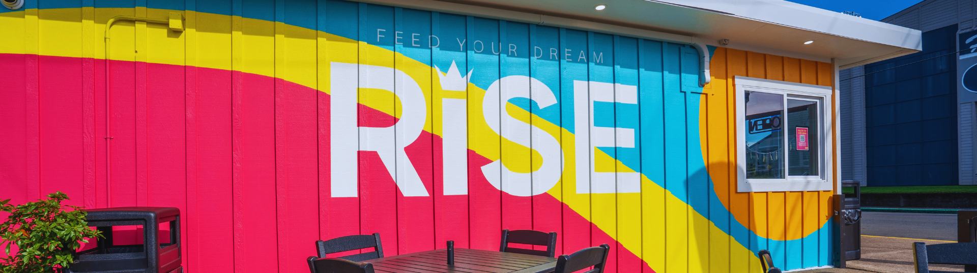 RISE Newport storefront with the Feed Your Dream mural on NE Eads Street